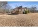 Expansive backyard with a two-story house, a large deck, and lush greenery, perfect for outdoor enjoyment at 30 Magnolia Dr, Oxford, GA 30054