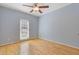 Cozy bedroom featuring light blue walls, hardwood floors, and a ceiling fan at 30 Magnolia Dr, Oxford, GA 30054