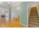 The foyer's hardwood floors lead to open living spaces and carpeted stairs, showcasing the home's layout at 30 Magnolia Dr, Oxford, GA 30054