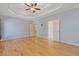 Spacious main bedroom with hardwood floors, tray ceiling, and multiple doors at 30 Magnolia Dr, Oxford, GA 30054