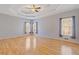 Large main bedroom with hardwood floors, tray ceiling, and many windows at 30 Magnolia Dr, Oxford, GA 30054