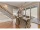 Stylish dining area adjacent to the staircase, offering a glimpse of the living room and patio at 505 Rocking Porch Way Way, Woodstock, GA 30189