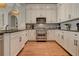 Modern kitchen featuring white cabinets, granite countertops, and stainless-steel appliances at 505 Rocking Porch Way, Woodstock, GA 30189