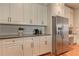 Kitchen area with stainless steel refrigerator, granite countertop, white cabinets, and wooden floor at 505 Rocking Porch Way Way, Woodstock, GA 30189