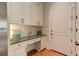 A kitchen desk area with white cabinets, granite countertops, and a dark door at 505 Rocking Porch Way Way, Woodstock, GA 30189