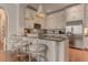 Gourmet kitchen featuring white cabinetry, stainless steel appliances, and a granite island at 505 Rocking Porch Way, Woodstock, GA 30189