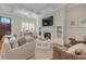 Inviting living room featuring a fireplace, coffered ceiling, and comfortable seating arrangement at 505 Rocking Porch Way Way, Woodstock, GA 30189