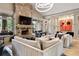 Bright living room featuring a stone fireplace, large windows, modern lighting, and plush seating at 505 Rocking Porch Way Way, Woodstock, GA 30189