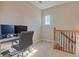 Bright office space with a desk setup, computer, and natural lighting near wooden staircase at 505 Rocking Porch Way, Woodstock, GA 30189