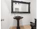 This bathroom features a pedestal sink with framed mirror and a black toilet at 538 Sarabrook Ne Pl, Atlanta, GA 30342