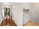 Butler's pantry featuring white cabinetry, tan countertops, and hardwood floors at 538 Sarabrook Ne Pl, Atlanta, GA 30342