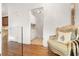 Hallway with hardwood floors, glass railings, and view of a butler's pantry at 538 Sarabrook Ne Pl, Atlanta, GA 30342