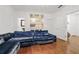 A living room featuring a blue velvet sectional sofa and hardwood floors at 538 Sarabrook Ne Pl, Atlanta, GA 30342