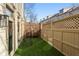 This is a charming fenced backyard with artificial turf and decorative lattice panels at 538 Sarabrook Ne Pl, Sandy Springs, GA 30342