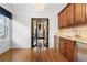 This is a bar area with wood cabinets and a view into the formal dining room at 538 Sarabrook Ne Pl, Sandy Springs, GA 30342