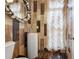 This is a stylish powder room with wood-look tile and a unique vessel sink at 538 Sarabrook Ne Pl, Sandy Springs, GA 30342