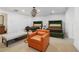 Bedroom featuring two beds, an orange chair, and a unique lighting fixture at 538 Sarabrook Ne Pl, Sandy Springs, GA 30342