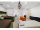 Bedroom featuring two beds, an orange chair, white leather couch, and black sideboard at 538 Sarabrook Ne Pl, Sandy Springs, GA 30342