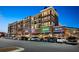 Exterior of a mixed-use building with retail and apartments, showcasing storefronts and ample parking at 538 Sarabrook Ne Pl, Sandy Springs, GA 30342