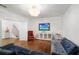Cozy living room featuring blue sofa, modern lighting, and hardwood floors at 538 Sarabrook Ne Pl, Sandy Springs, GA 30342
