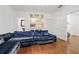 Comfortable living room with plush blue sofa, hardwood floors, and unique mirrored console at 538 Sarabrook Ne Pl, Sandy Springs, GA 30342