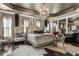 Opulent main bedroom featuring a chandelier, mirrored accents and custom draperies at 538 Sarabrook Ne Pl, Sandy Springs, GA 30342