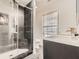 Bathroom featuring a frameless shower with marble look tile and brushed gold fixtures at 775 Welch Sw St, Atlanta, GA 30310