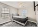 Bedroom featuring a large bed, carpeted floors, ceiling fan and two windows at 775 Welch Sw St, Atlanta, GA 30310