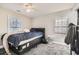 Cozy bedroom featuring carpeted floor, ceiling fan and two windows at 775 Welch Sw St, Atlanta, GA 30310