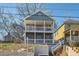 Two-story home with double porches, situated on a hill, featuring a red door at 775 Welch Sw St, Atlanta, GA 30310