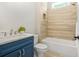 Bathroom showcasing a blue vanity, quartz countertop, and tiled shower at 1078 Amarose Ln, Marietta, GA 30066