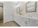 Elegant bathroom featuring double vanities, white cabinets, and decorative mirrors at 1078 Amarose Ln, Marietta, GA 30066