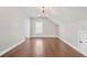 Spacious bedroom featuring hardwood floors, a chandelier, neutral walls, and multiple windows at 1078 Amarose Ln, Marietta, GA 30066