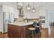 Stylish kitchen with stainless steel refrigerator, marble countertops, and barstool seating at 1078 Amarose Ln, Marietta, GA 30066