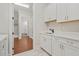 Bright laundry room with cabinets, a sink and modern appliances, featuring a seamless blend of style and functionality at 1078 Amarose Ln, Marietta, GA 30066