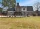 Exterior view of home's backyard featuring a dark brick exterior, fenced yard and green grass at 149 Fishers Mill Dr, Mcdonough, GA 30252