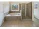 Relaxing bathroom featuring a jacuzzi tub and glass shower at 149 Fishers Mill Dr, Mcdonough, GA 30252