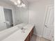 Bright bathroom featuring a large mirror, white countertop, and wooden cabinets at 149 Fishers Mill Dr, Mcdonough, GA 30252