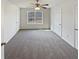 Spacious bedroom with neutral carpet, a ceiling fan and natural light from a large window at 149 Fishers Mill Dr, Mcdonough, GA 30252