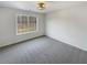 Bedroom featuring plush carpeting, a modern light fixture, and a view to the backyard at 149 Fishers Mill Dr, Mcdonough, GA 30252