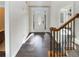 Bright entryway with wood floors, decorative door, and elegant staircase at 149 Fishers Mill Dr, Mcdonough, GA 30252