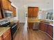 Modern kitchen featuring stainless steel appliances, granite countertops, and wood cabinets at 149 Fishers Mill Dr, Mcdonough, GA 30252