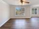 Bright living area with hardwood floors, crown moulding and a view of the yard at 149 Fishers Mill Dr, Mcdonough, GA 30252