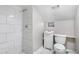 Modern bathroom featuring a tiled walk-in shower and a pedestal sink, offering a clean and stylish design at 174 Howard Nw St, Atlanta, GA 30314