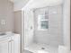 Modern bathroom showcases a tiled walk-in shower, vanity, and hexagon-tiled floor, creating a spa-like retreat at 174 Howard Nw St, Atlanta, GA 30314