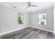 Bedroom featuring two windows that provide ample natural light and new vinyl flooring at 174 Howard Nw St, Atlanta, GA 30314