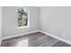 This bedroom has a large window with natural light and wood-look vinyl flooring at 174 Howard Nw St, Atlanta, GA 30314