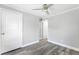 Bedroom featuring a ceiling fan, ample closet space, and new vinyl flooring at 174 Howard Nw St, Atlanta, GA 30314