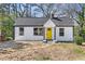 Charming renovated single-story home with a bright yellow front door and fresh landscaping at 174 Howard Nw St, Atlanta, GA 30314