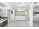 An empty kitchen features white cabinets, tile flooring, and granite countertops, perfect for culinary creations at 174 Howard Nw St, Atlanta, GA 30314